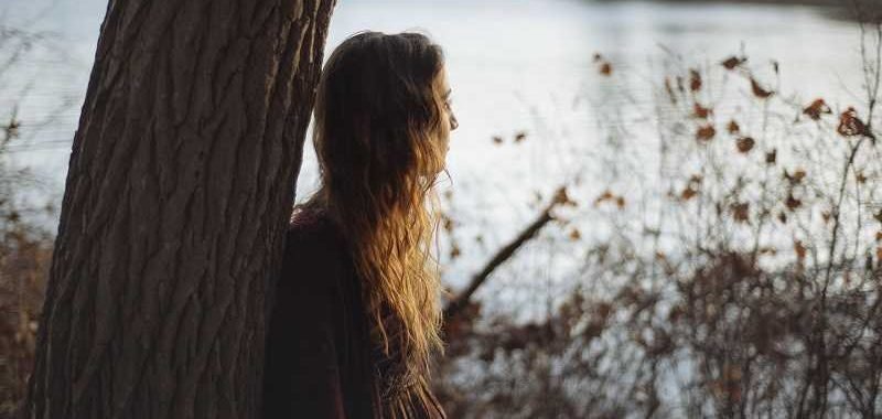 what do I want? A woman is looking at a lake